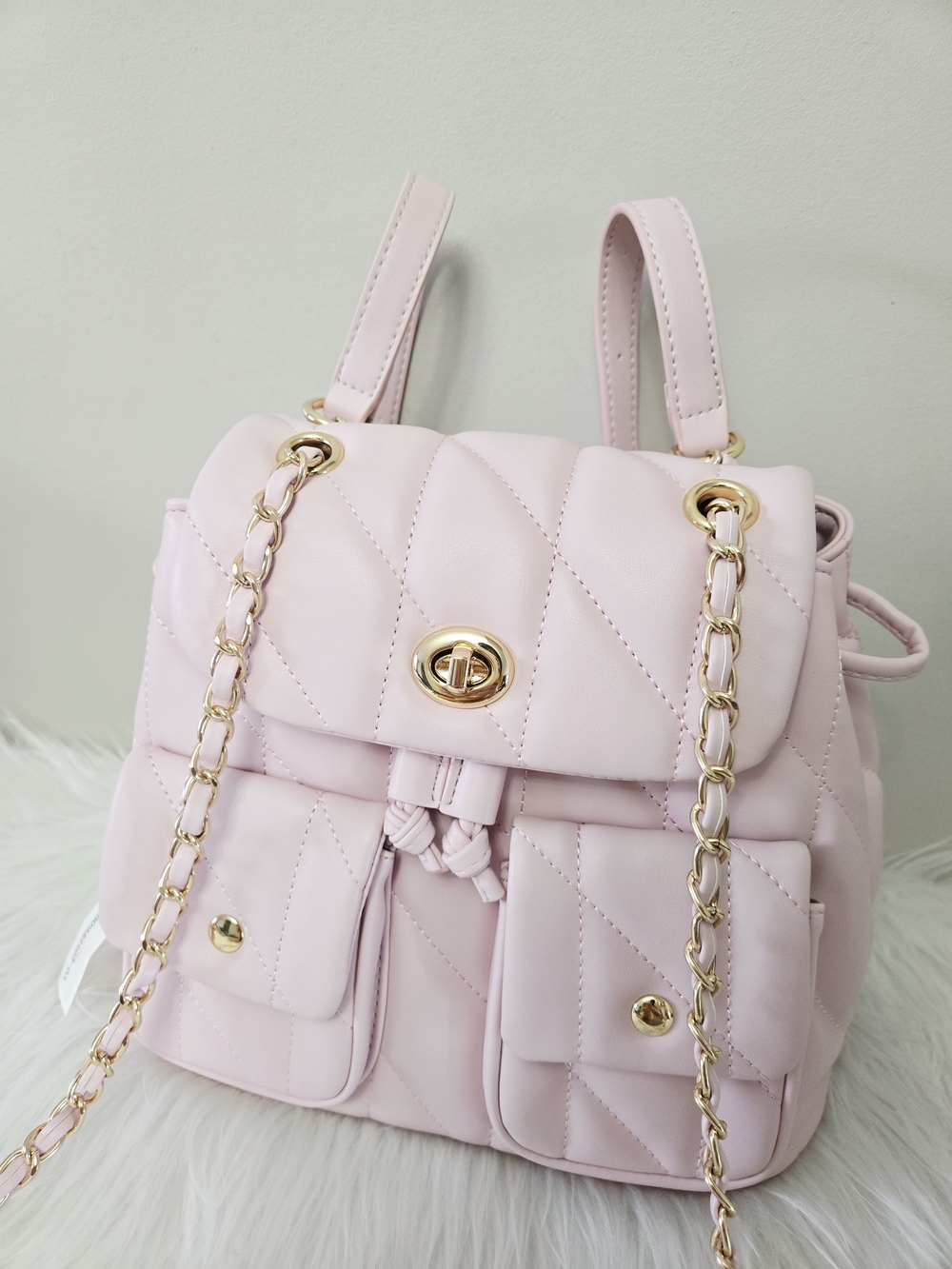 Elegant Quilted Pink Backpack with Gold Chain Accents